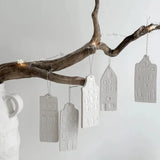 Scandinavian-inspired porcelain house ornaments in white