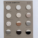Minimalist ceramic disc wall hanging with gray and white discs