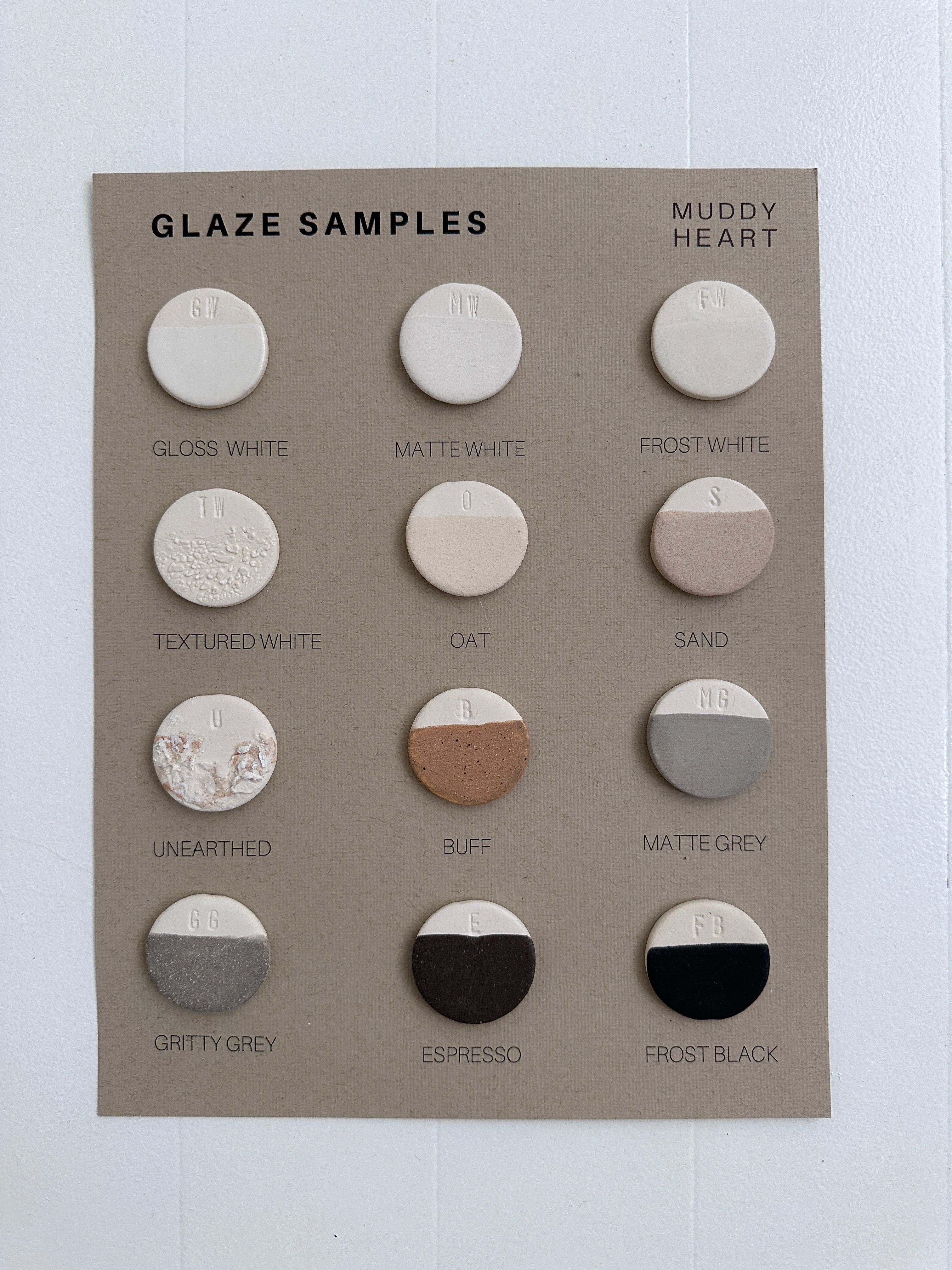 Minimalist ceramic disc wall hanging with gray and white discs