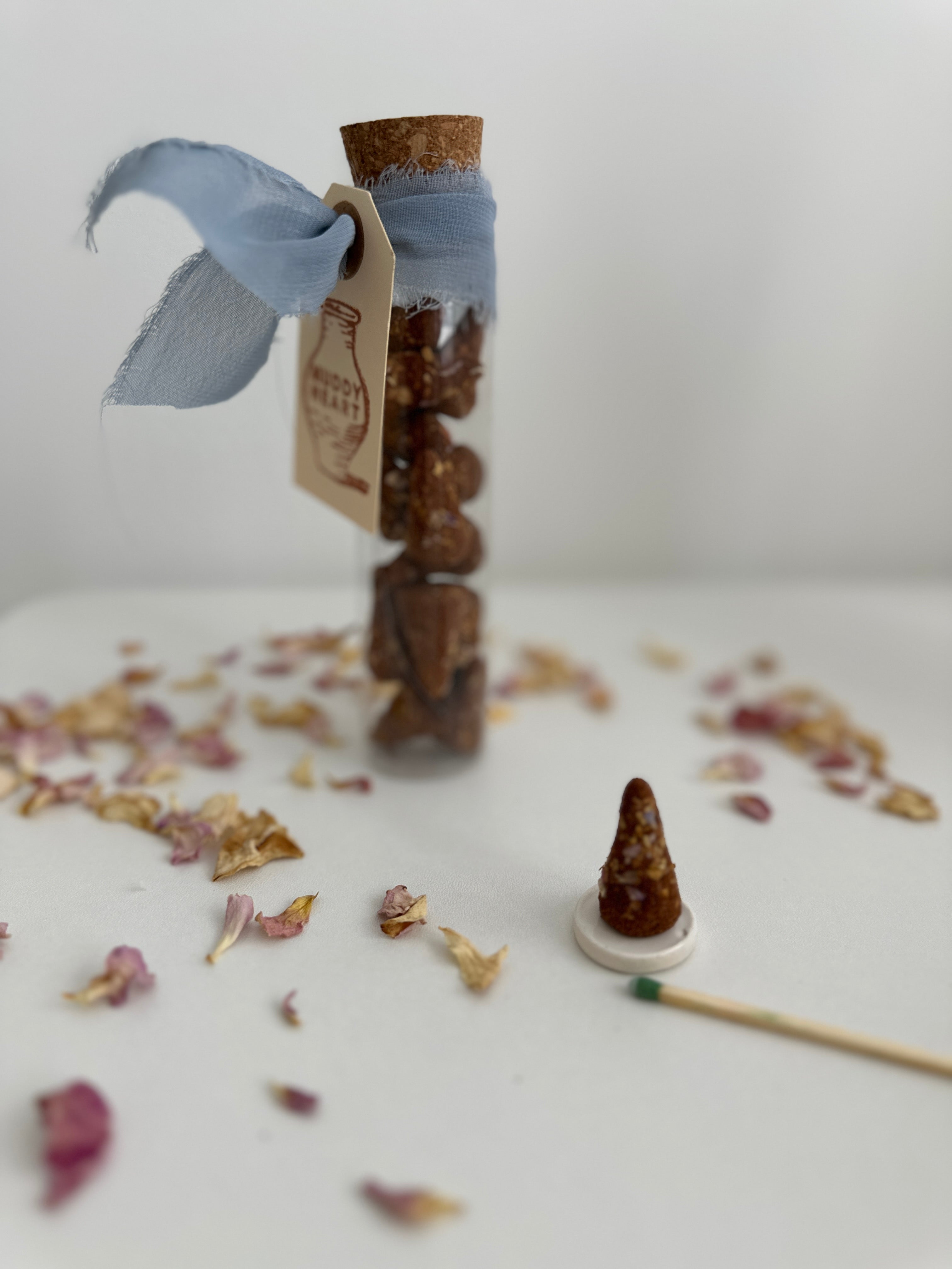 Natural incense cones shown with a scent vial
