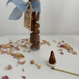 Natural incense cones with a lit cone releasing scented smoke