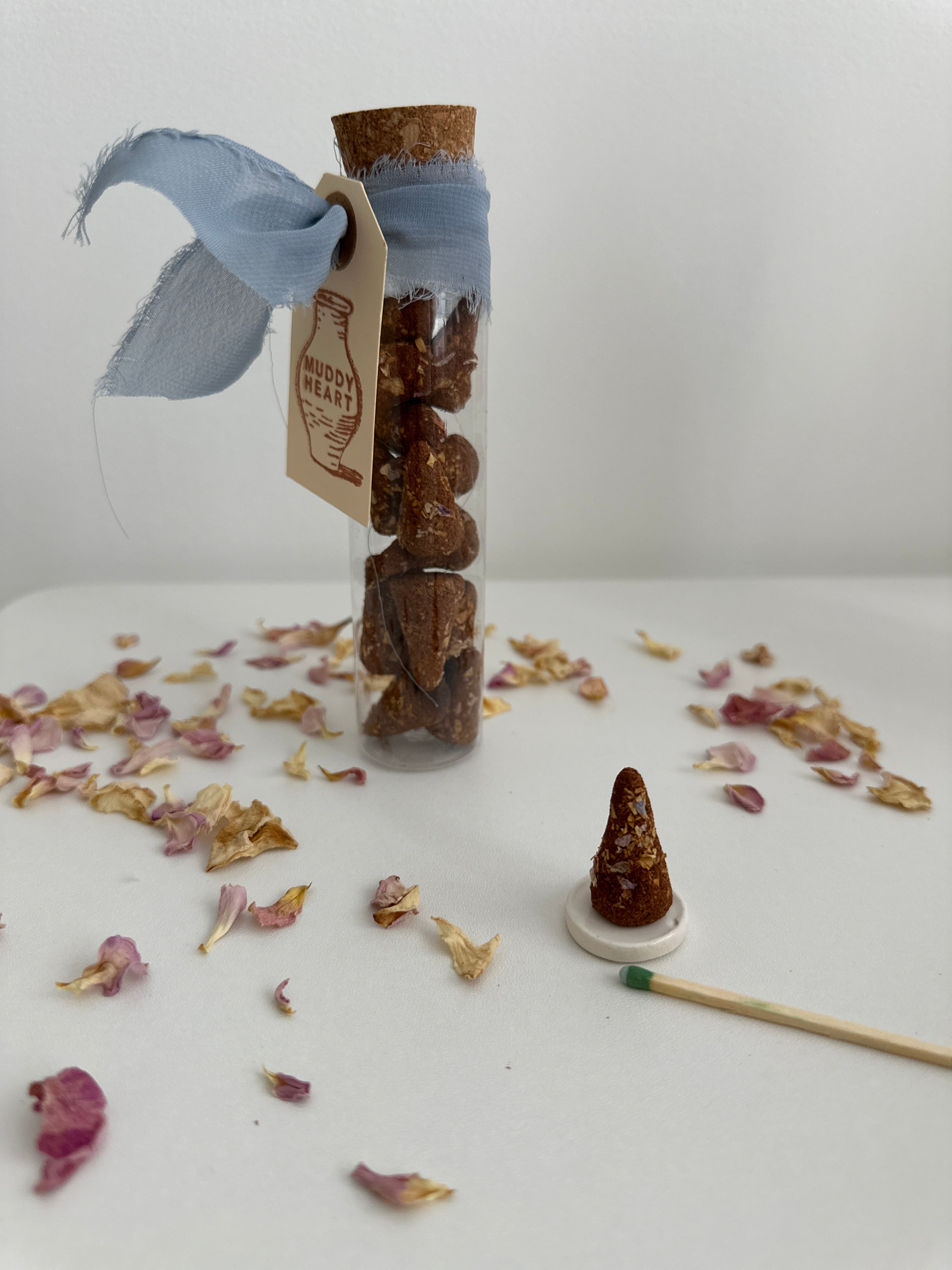 Natural incense cones with a lit cone releasing scented smoke