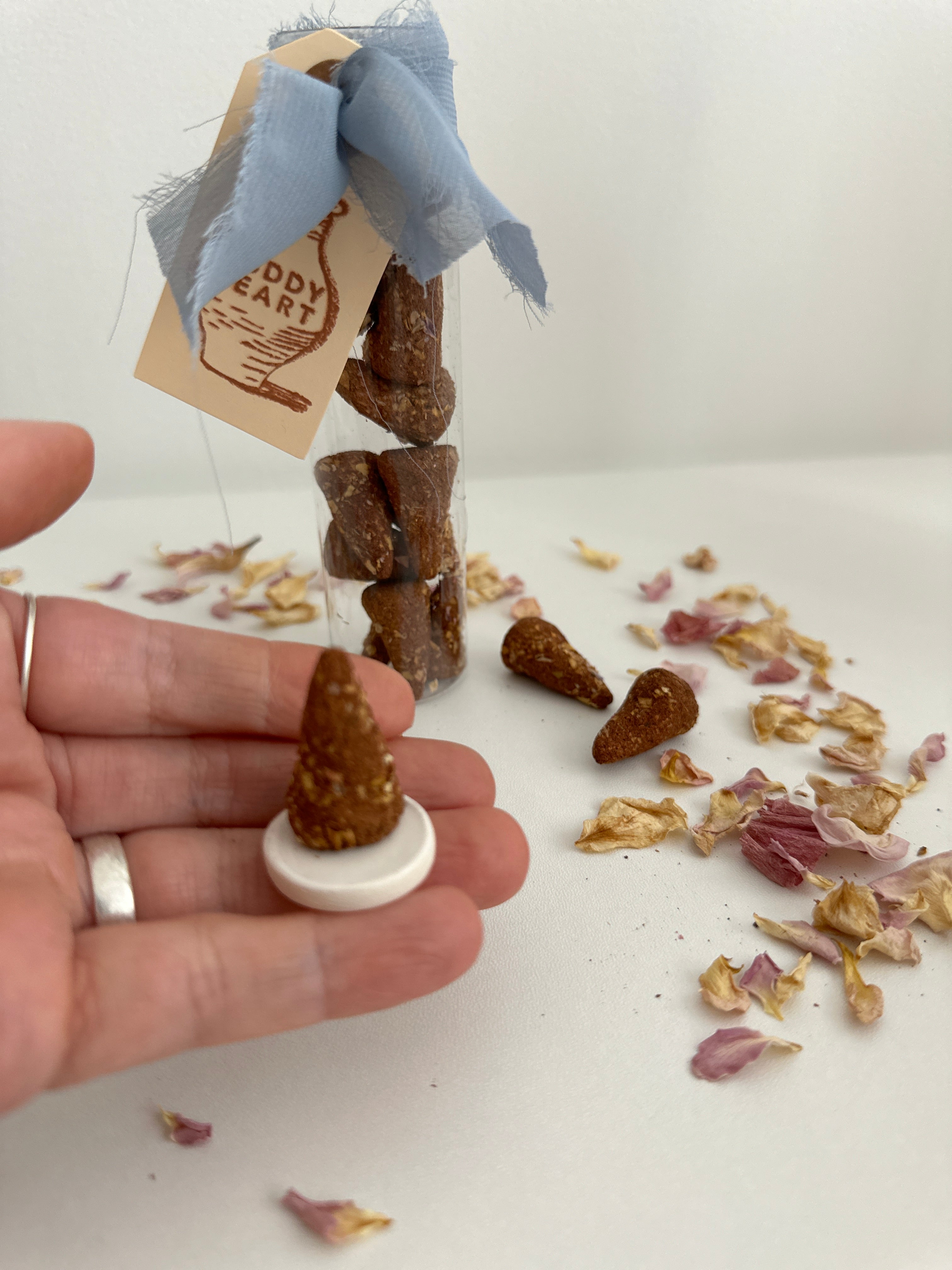 Natural incense cones beside a ceramic burner disc