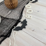 Handmade stoneware garland spelling BOO in ceramic letters on natural cotton rope.