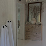 Handmade stoneware garland spelling BOO in ceramic letters on natural cotton rope.