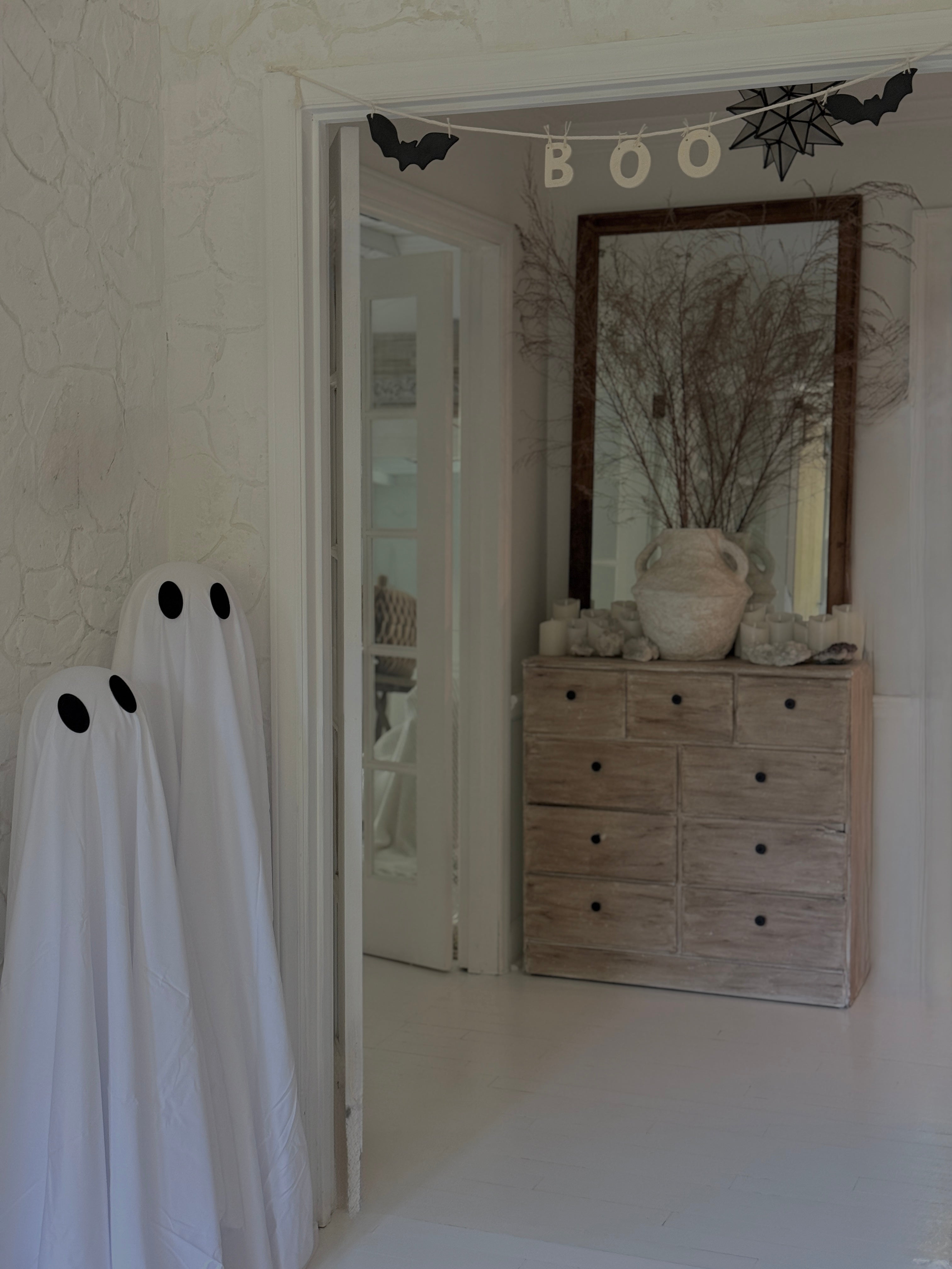 Handmade stoneware garland spelling BOO in ceramic letters on natural cotton rope.