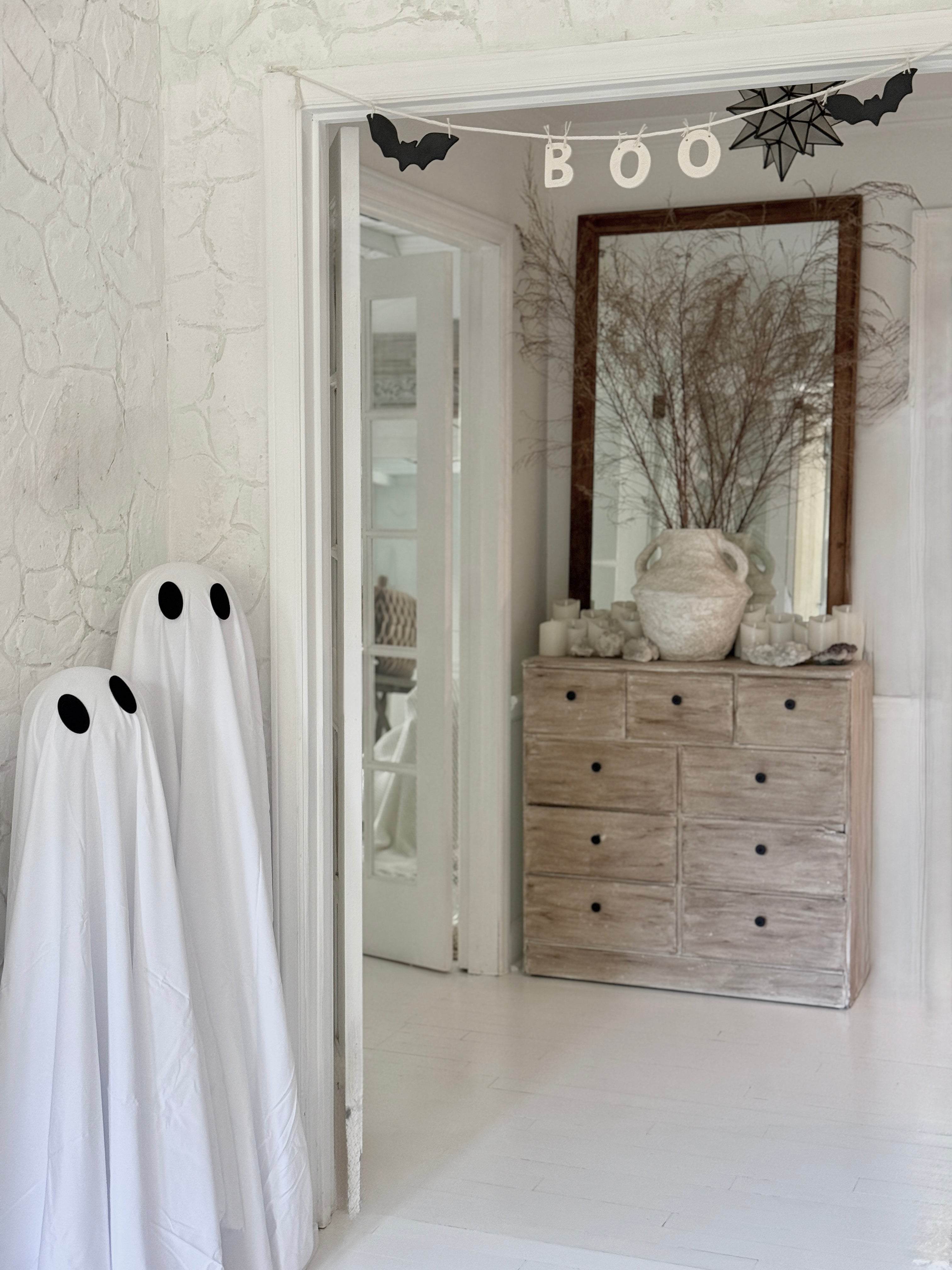 Handmade stoneware garland spelling BOO in ceramic letters on natural cotton rope.