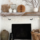 Handmade stoneware Halloween garland spelling SPOOKY on natural cotton rope in neutral tones.
