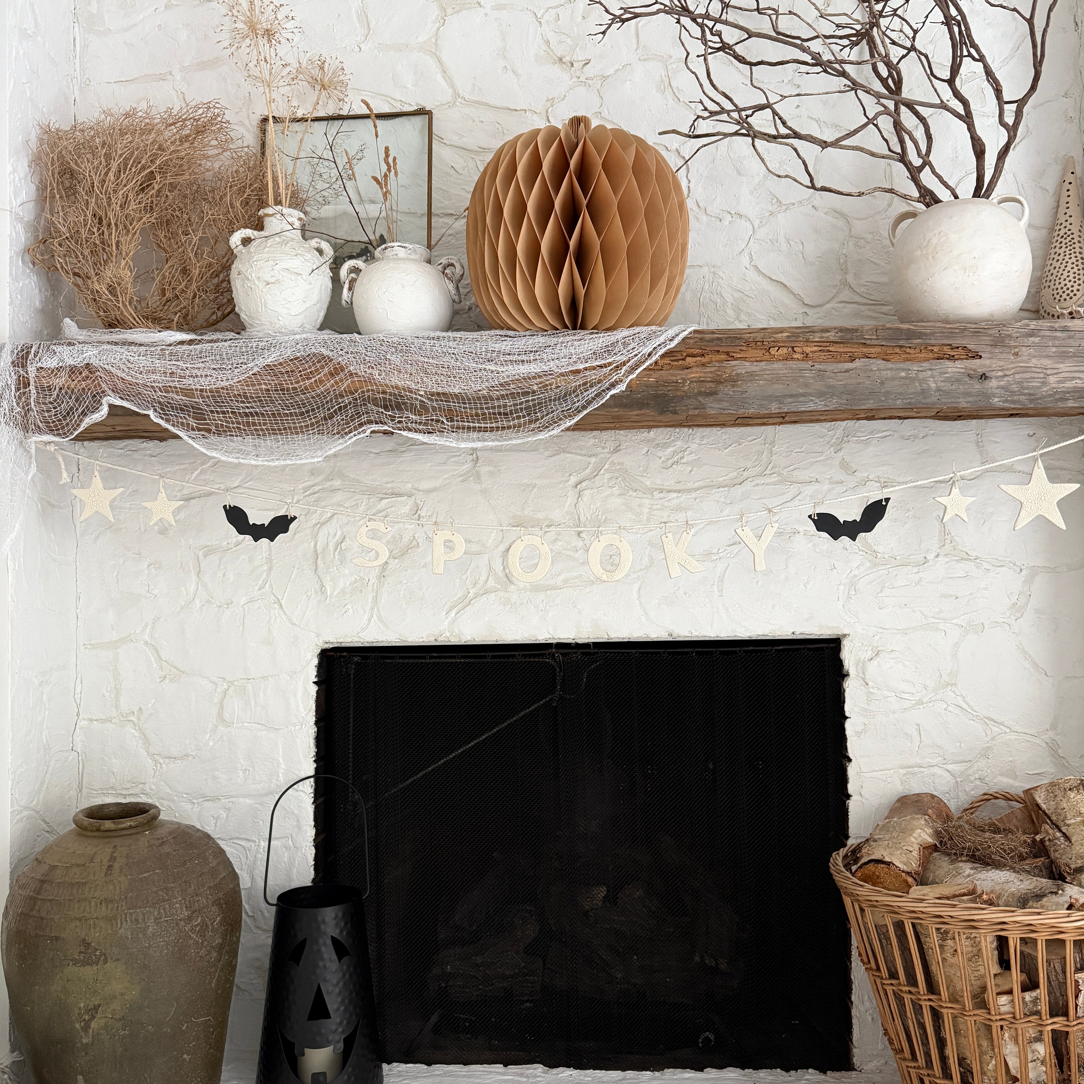 Handmade stoneware Halloween garland spelling SPOOKY on natural cotton rope in neutral tones.
