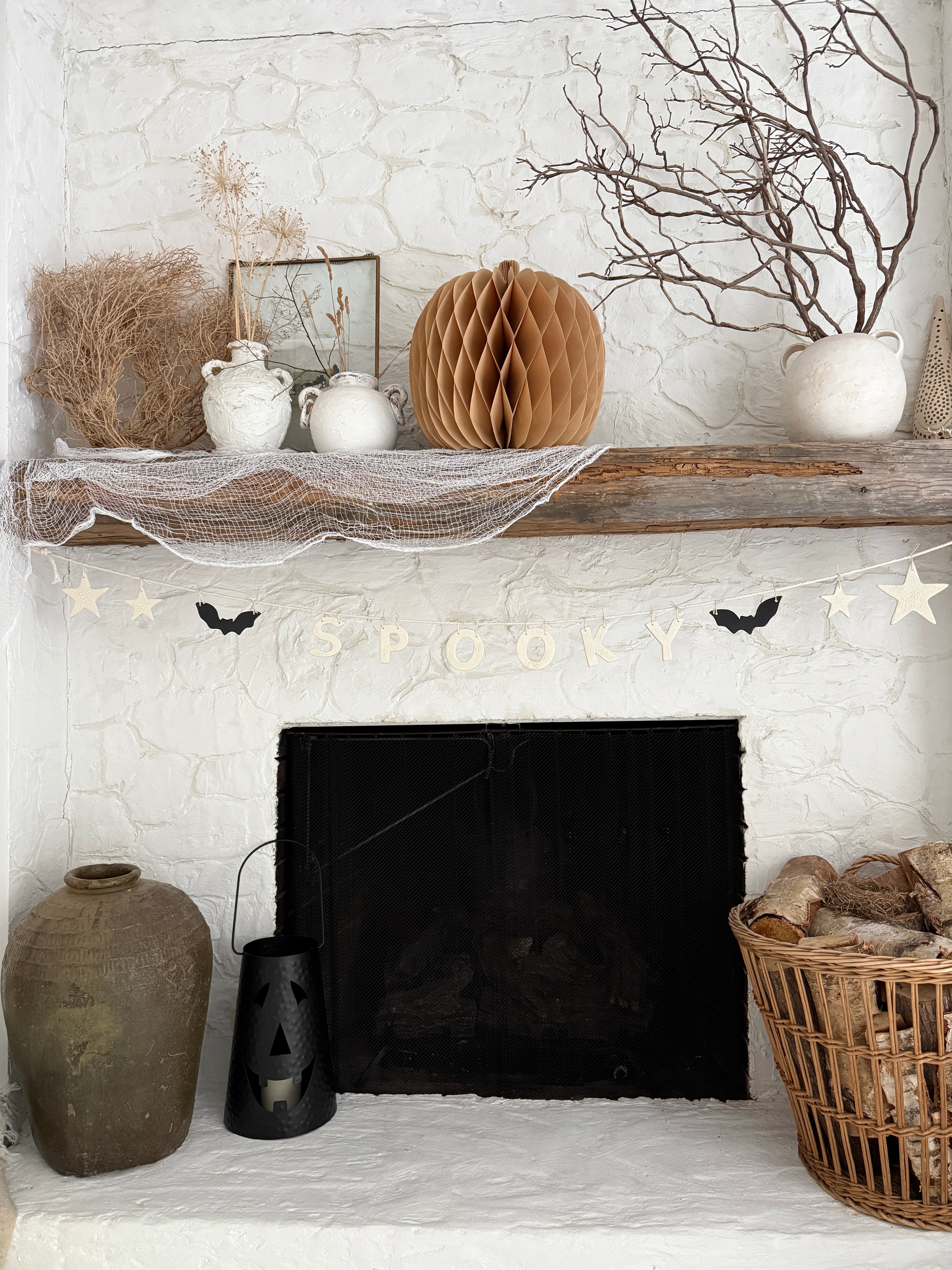 Handmade stoneware Halloween garland spelling SPOOKY on natural cotton rope in neutral tones.