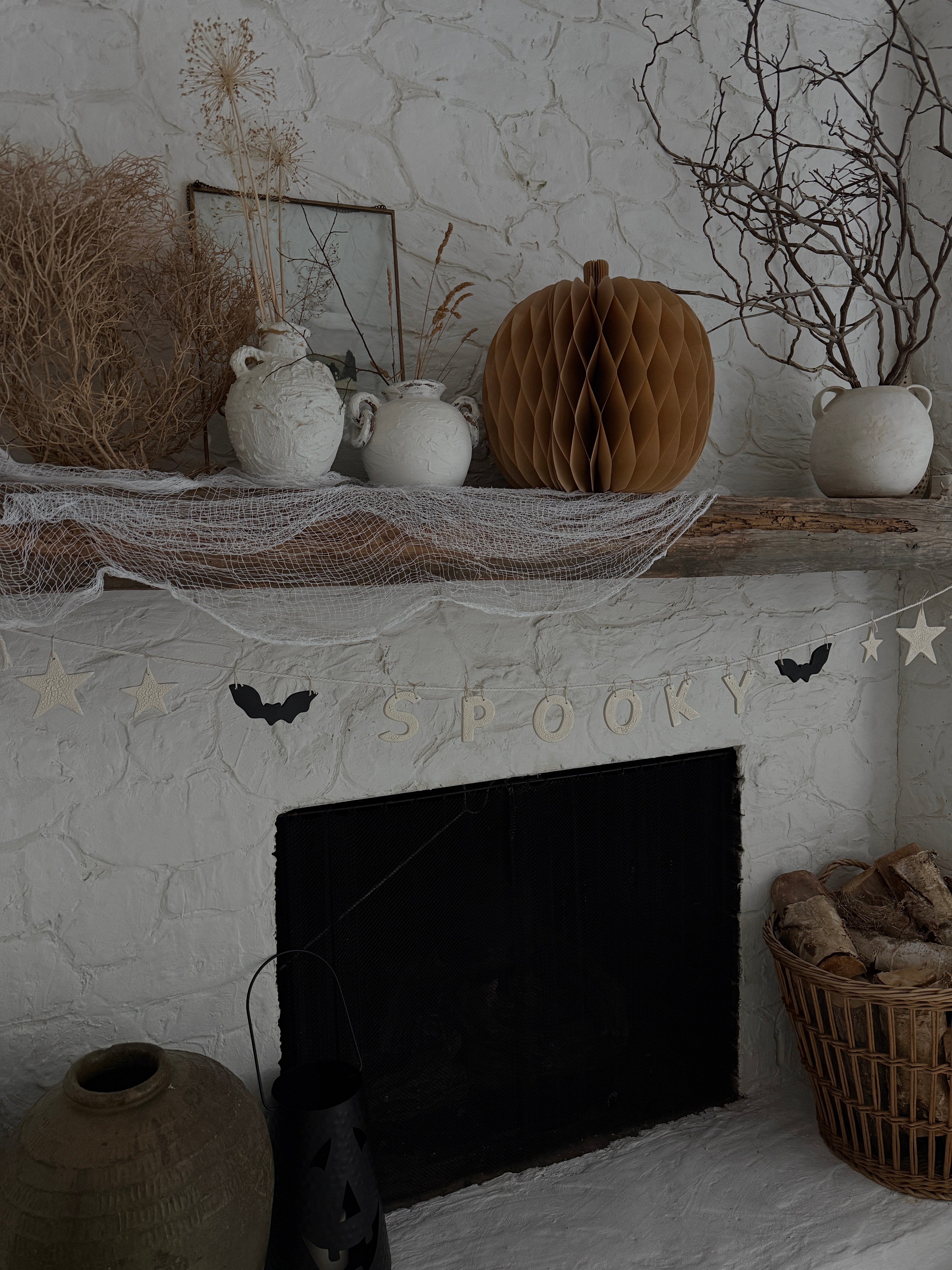 Handmade stoneware Halloween garland spelling SPOOKY on natural cotton rope in neutral tones.