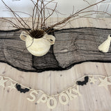 Handmade stoneware Halloween garland spelling SPOOKY on natural cotton rope in neutral tones.