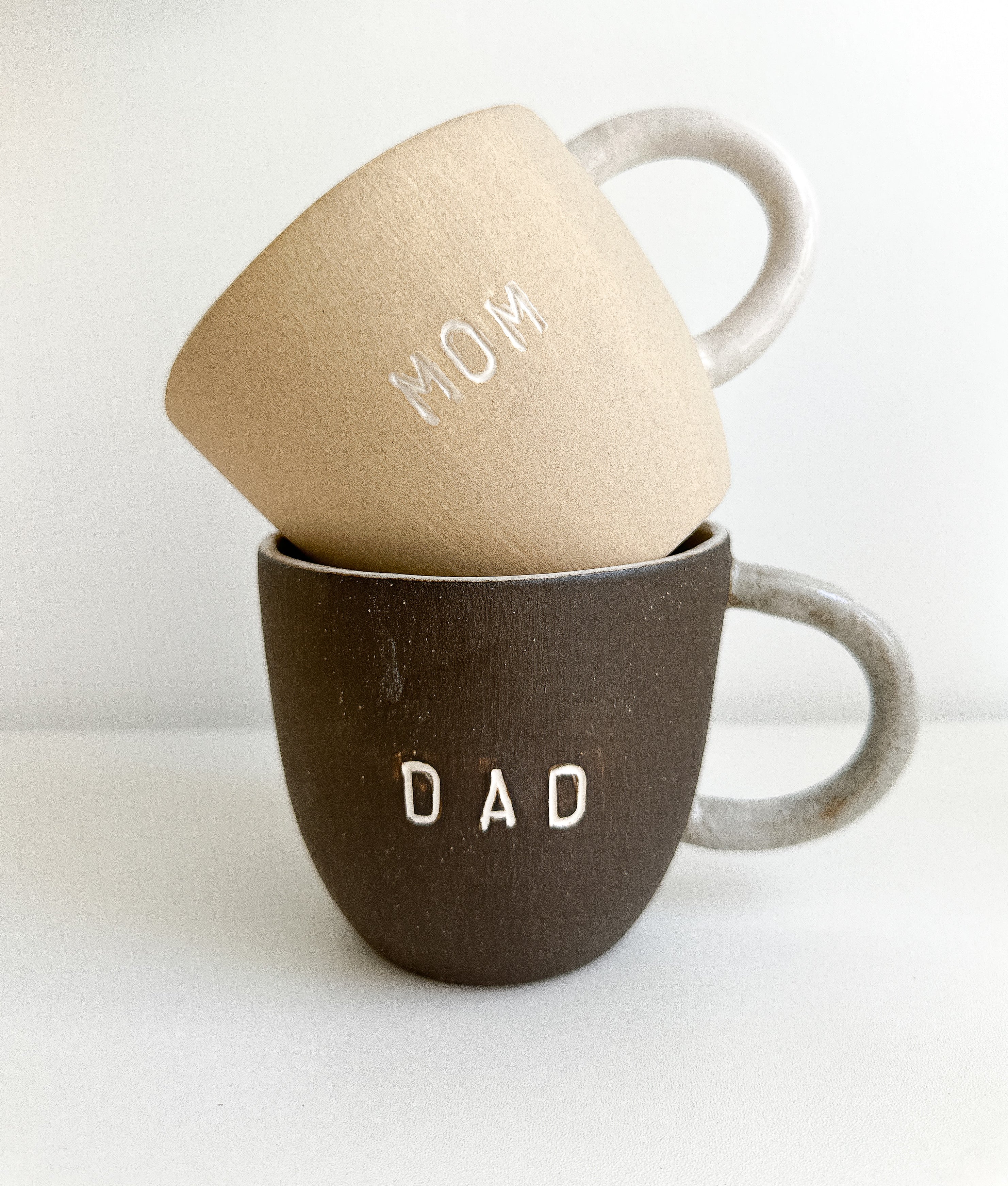 Personalized Mom & Dad ceramic mugs with clean lettering