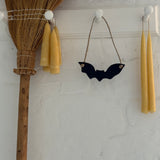 Handmade stoneware bat ornaments in three sizes for hanging on knobs, branches, or wreaths.