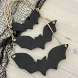 Handmade stoneware bat ornaments in three sizes for hanging on knobs, branches, or wreaths.