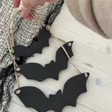 Handmade stoneware bat ornaments in three sizes for hanging on knobs, branches, or wreaths.