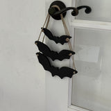 Handmade stoneware bat ornaments in three sizes for hanging on knobs, branches, or wreaths.