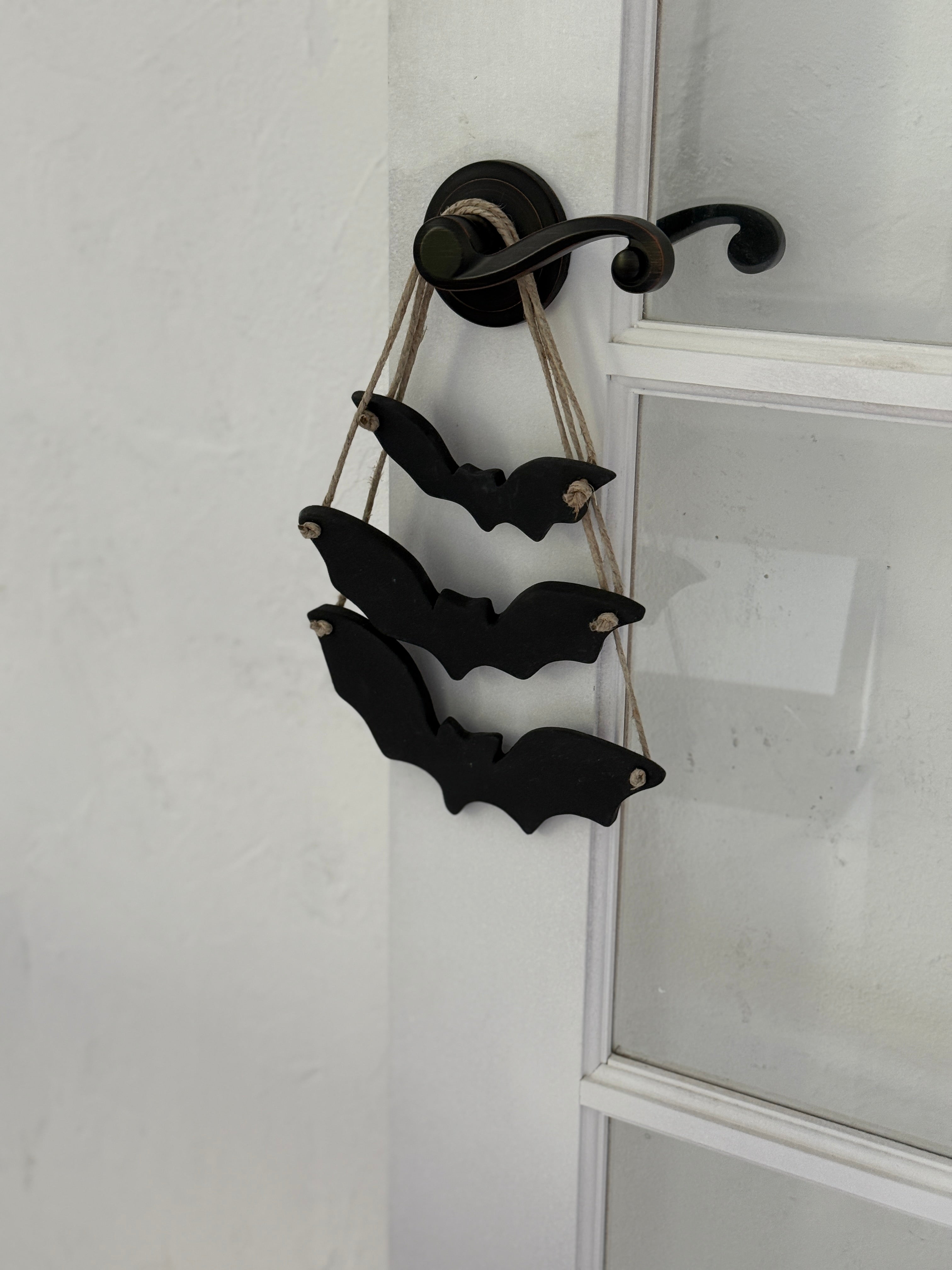 Handmade stoneware bat ornaments in three sizes for hanging on knobs, branches, or wreaths.