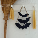 Handmade stoneware bat ornaments in three sizes for hanging on knobs, branches, or wreaths.