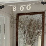 Handmade stoneware garland spelling BOO in ceramic letters on natural cotton rope.