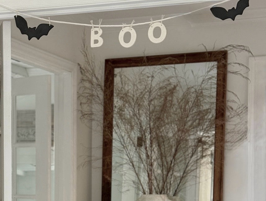 Handmade stoneware garland spelling BOO in ceramic letters on natural cotton rope.