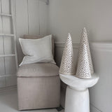 Handmade stoneware tree luminary with star cutouts glowing from an LED tea light