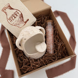 Handmade ceramic Stanley the salt monster crock with a gourmet salt blend, packaged as a gift.