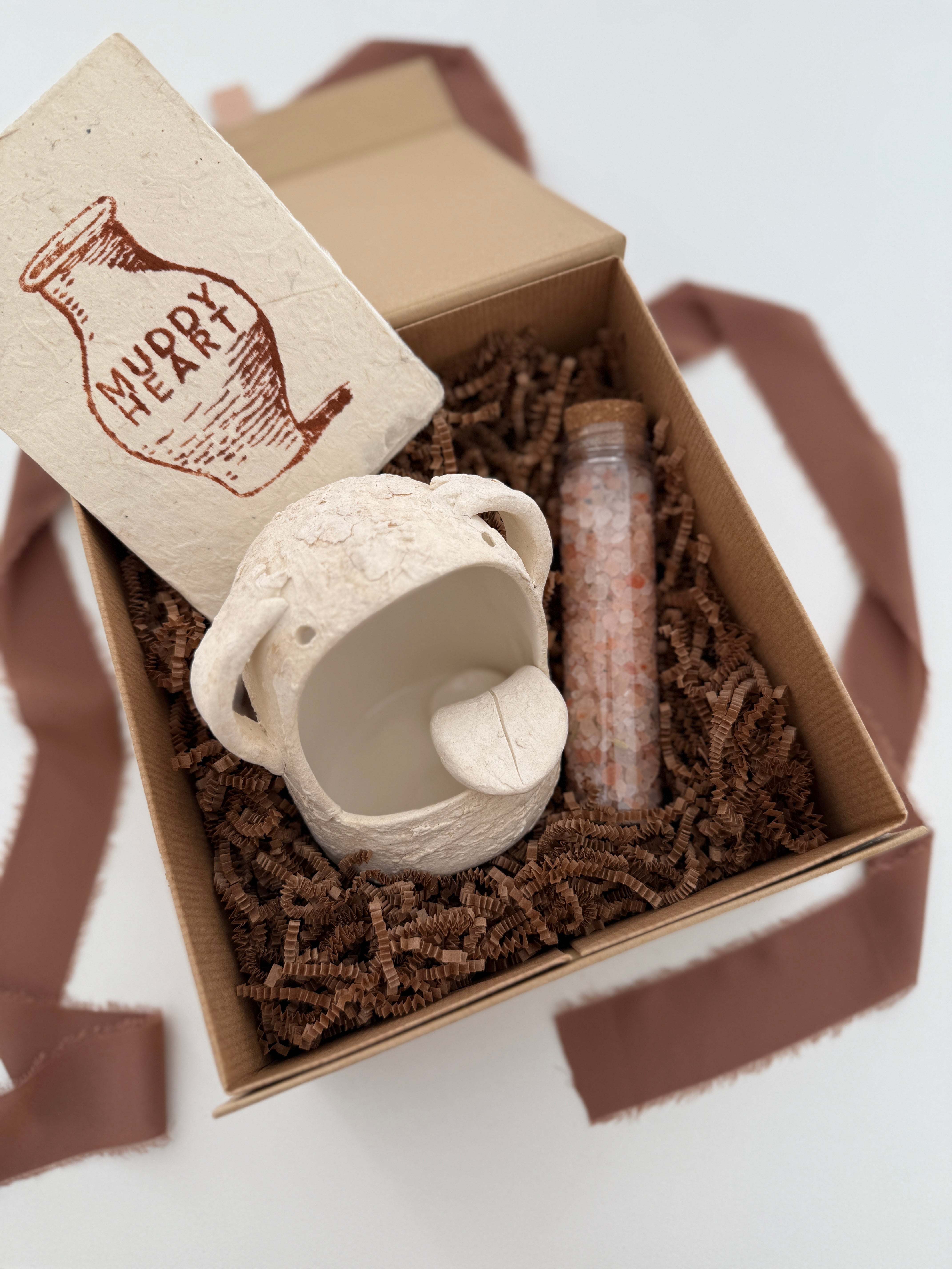 Handmade ceramic Stanley the salt monster crock with a gourmet salt blend, packaged as a gift.