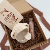 Handmade ceramic Stanley the salt monster crock with a gourmet salt blend, packaged as a gift.
