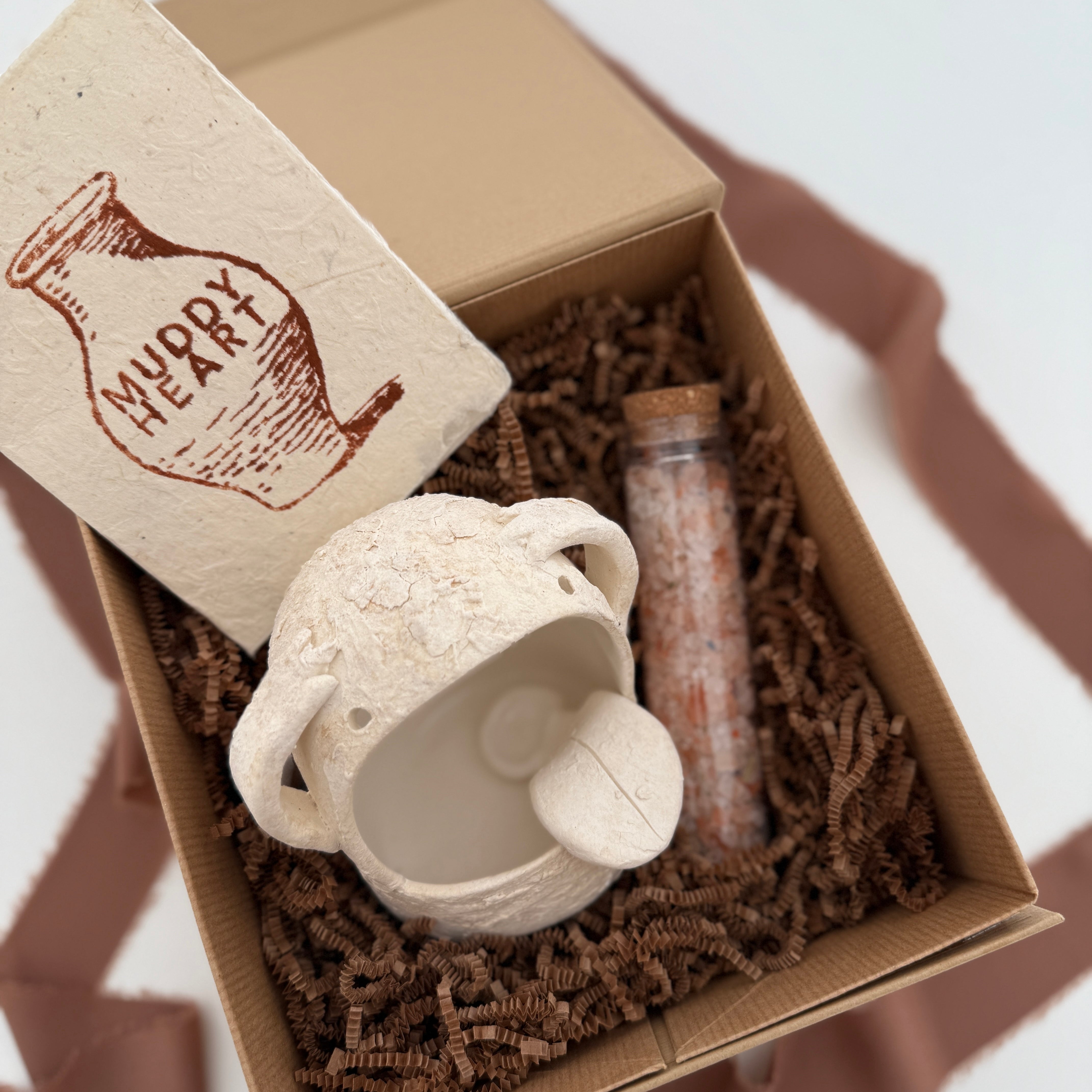 Handmade ceramic Stanley the salt monster crock with a gourmet salt blend, packaged as a gift.
