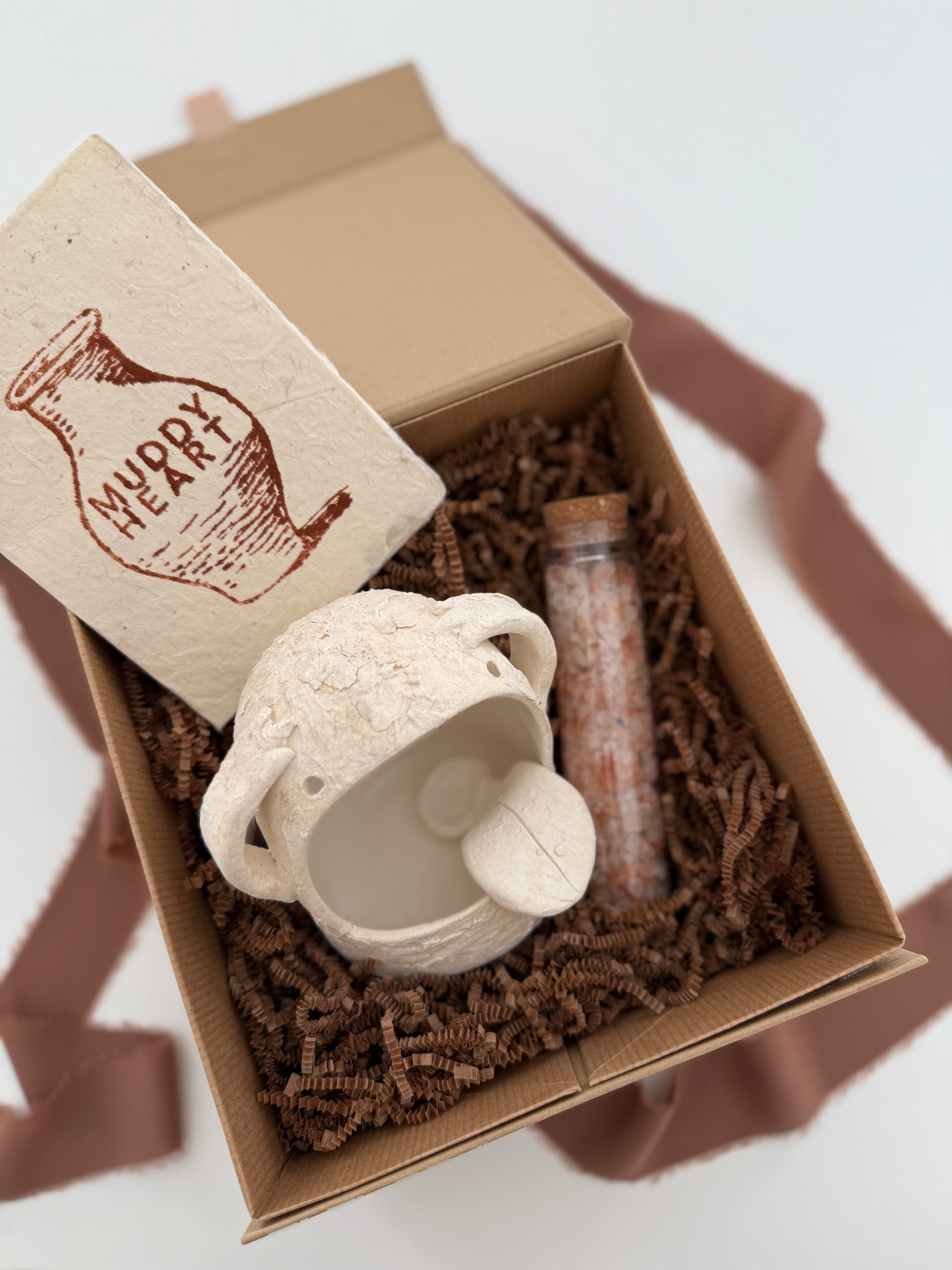 Handmade ceramic Stanley the salt monster crock with a gourmet salt blend, packaged as a gift.