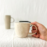 Assorted handmade ceramic mugs with textured glazes, dishwasher-safe seconds-sale pieces from Muddy Heart
