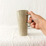 Assorted handmade ceramic mugs with textured glazes, dishwasher-safe seconds-sale pieces from Muddy Heart