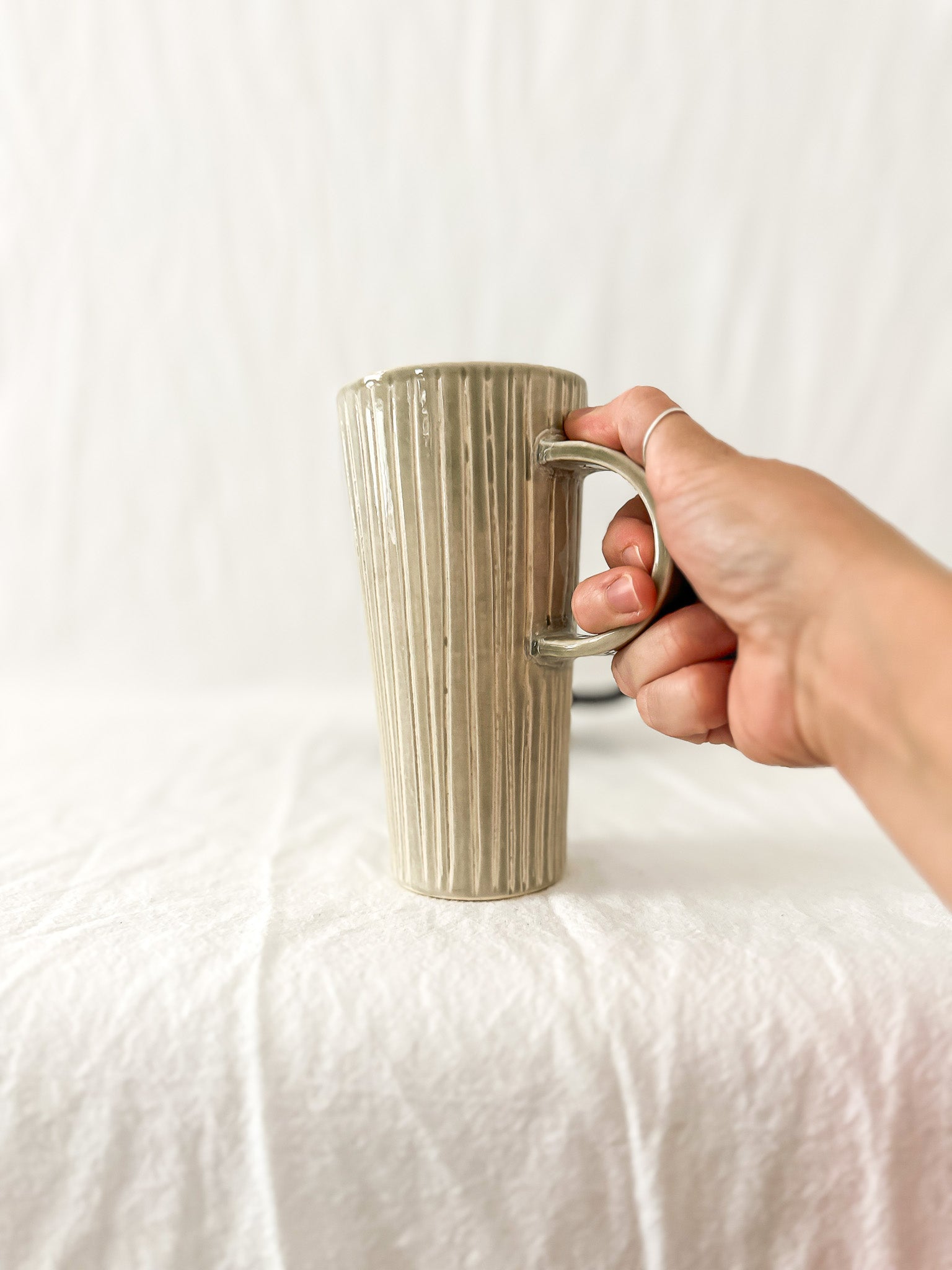 Assorted handmade ceramic mugs with textured glazes, dishwasher-safe seconds-sale pieces from Muddy Heart