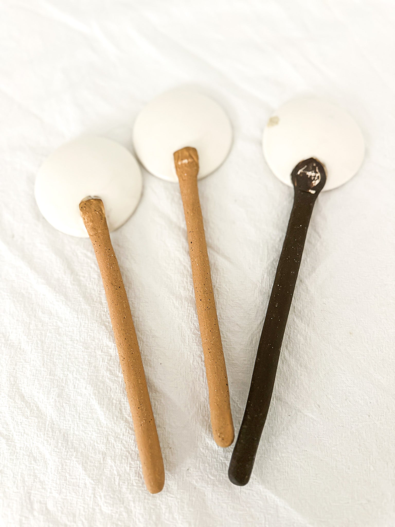 Handmade ceramic coffee and spice spoons in buff and espresso glazes, seconds-sale pieces from Muddy Heart