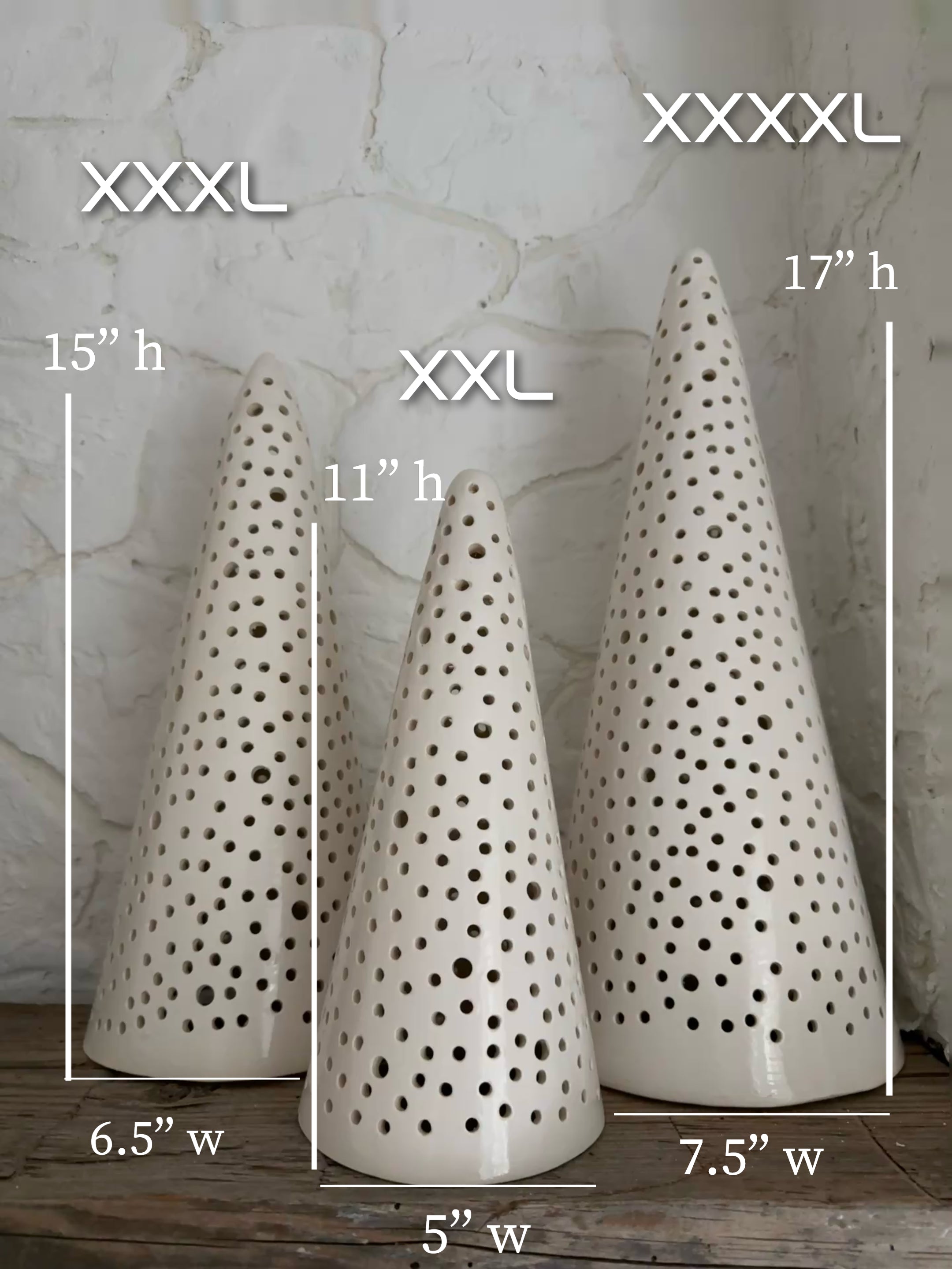 Handmade stoneware tree luminary with star cutouts glowing from an LED tea light