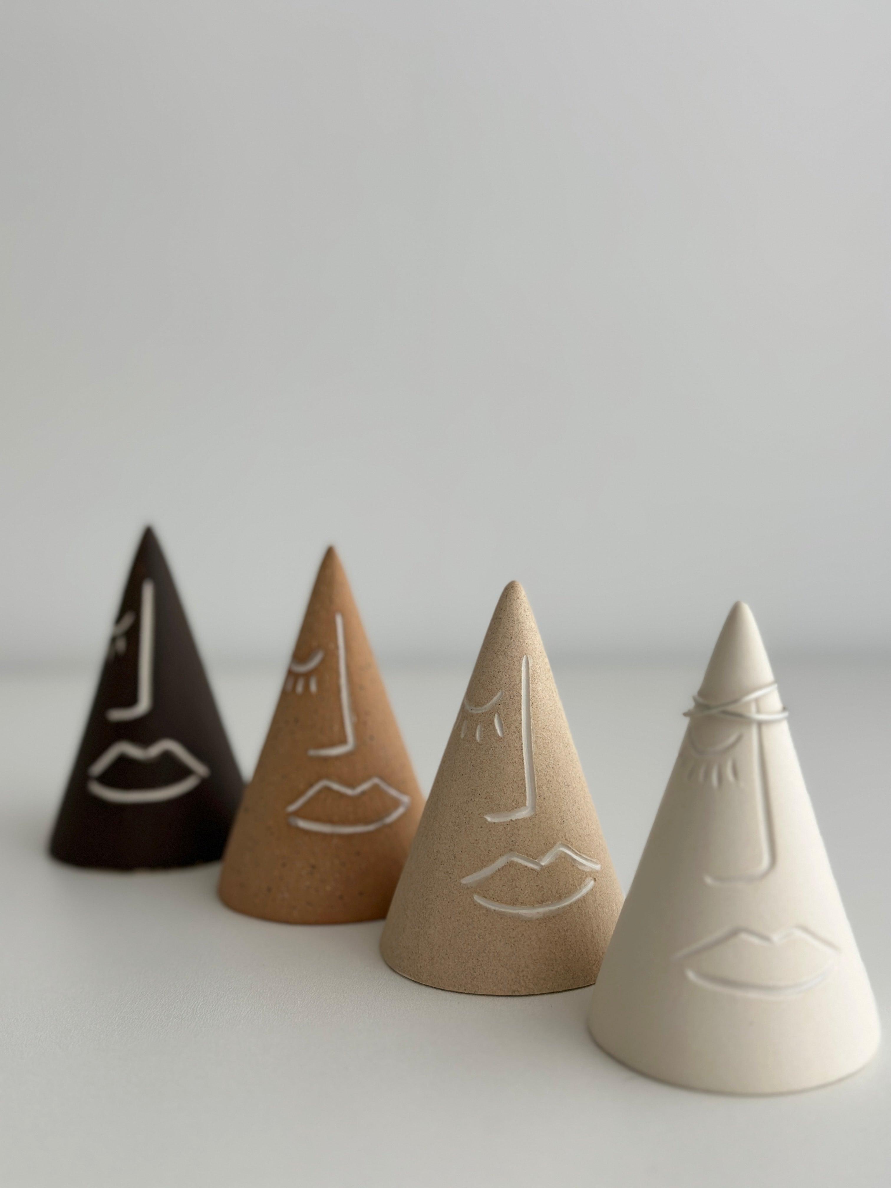 Unique abstract face ring holders in brown, tan, and beige