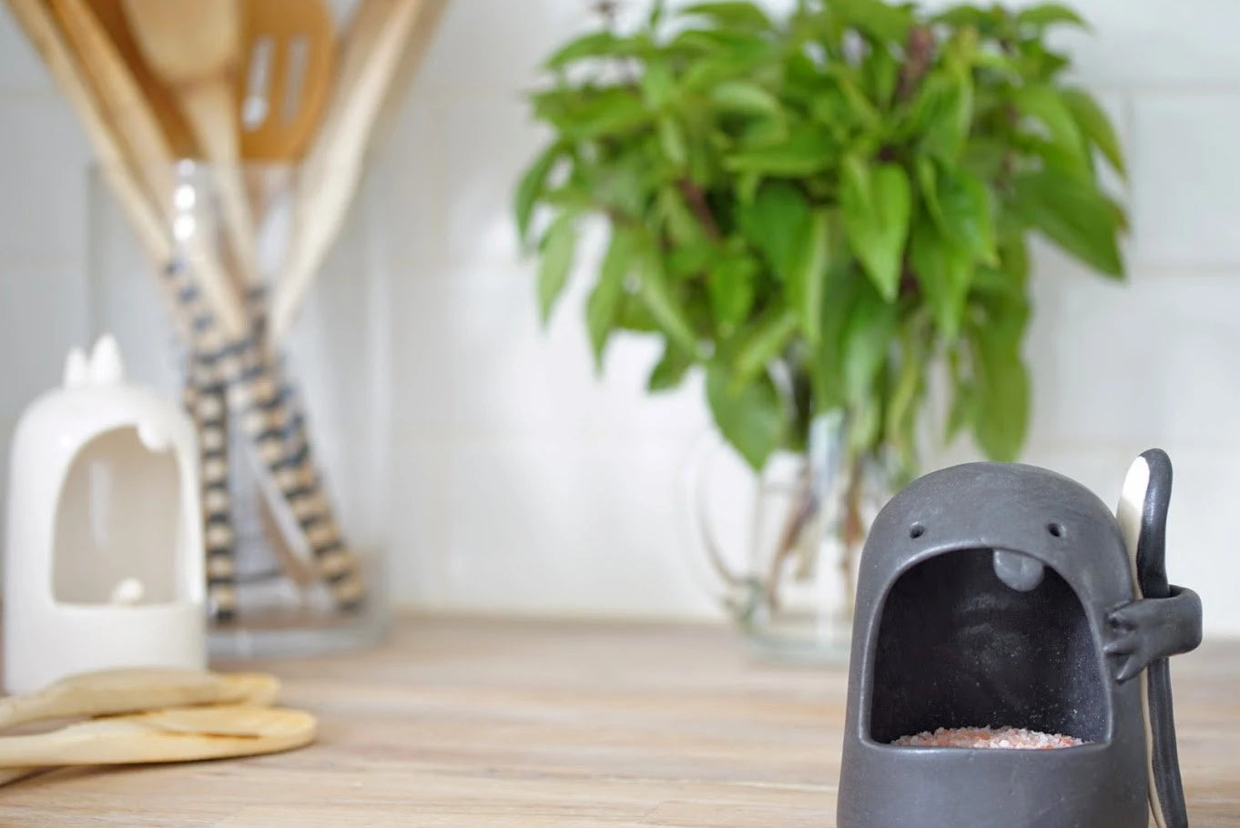 Whimsical handmade ceramic salt keeper shaped like a smiling monster
