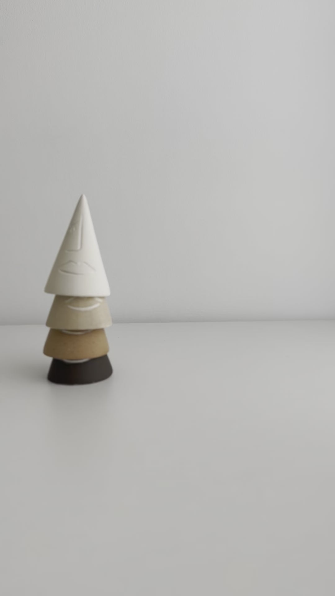Neutral tone ring cones with abstract face illustrations for modern decor
