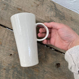 Handmade tall ceramic mug with delicate lace texture