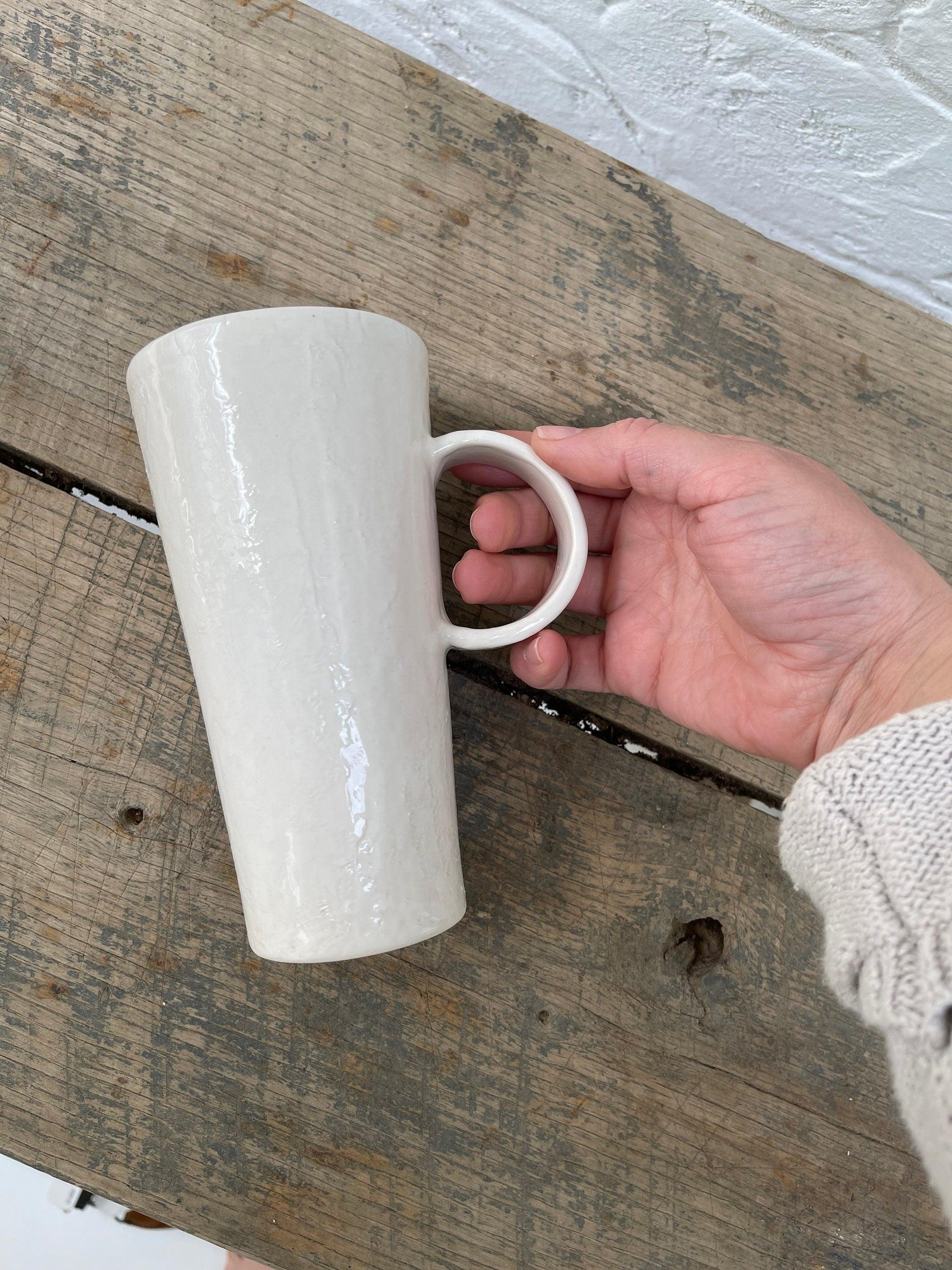 Handmade tall ceramic mug with delicate lace texture