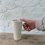 Handmade tall ceramic mug with delicate lace texture