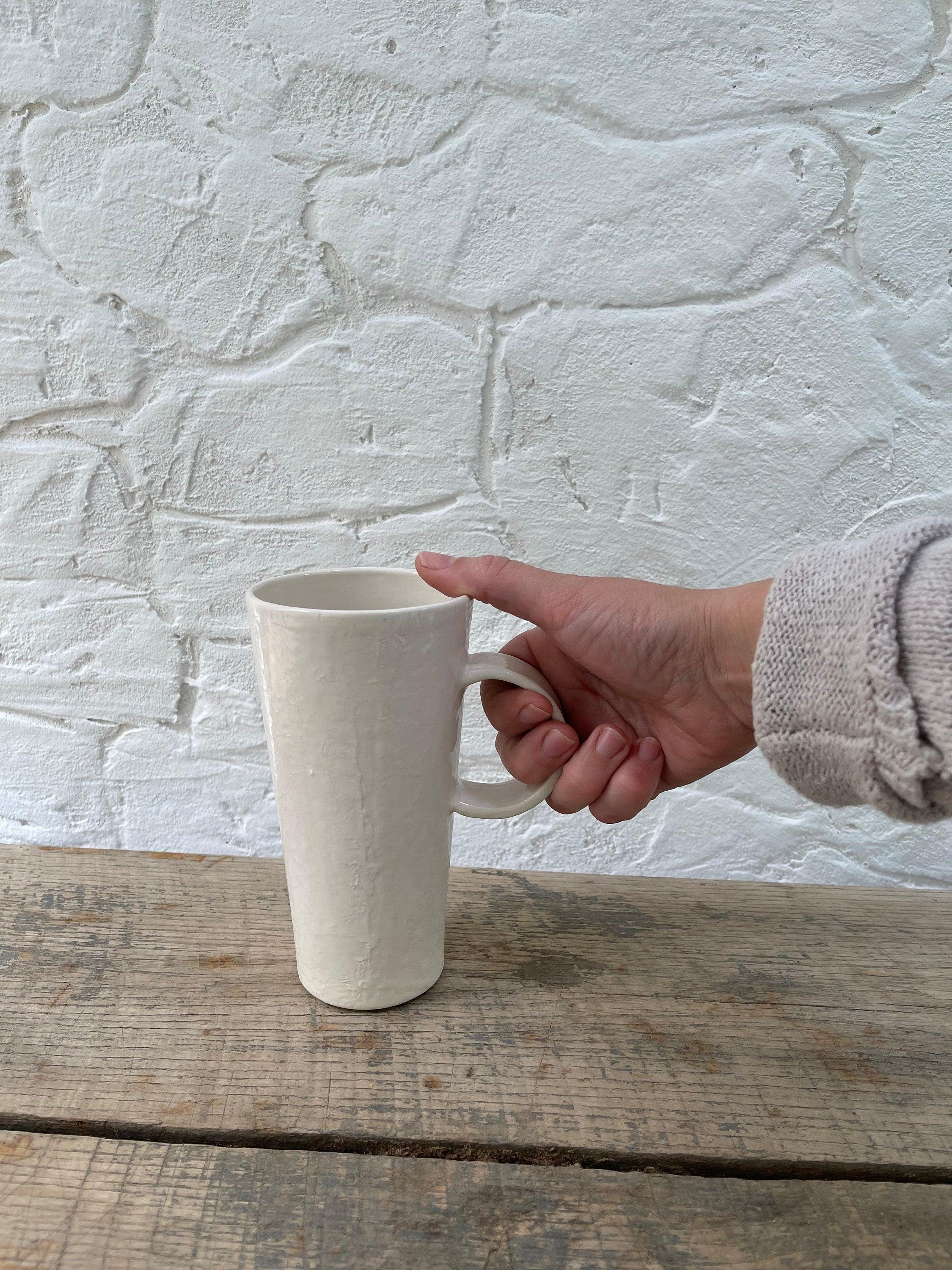 Handmade tall ceramic mug with delicate lace texture