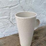 Handmade tall ceramic mug with delicate lace texture