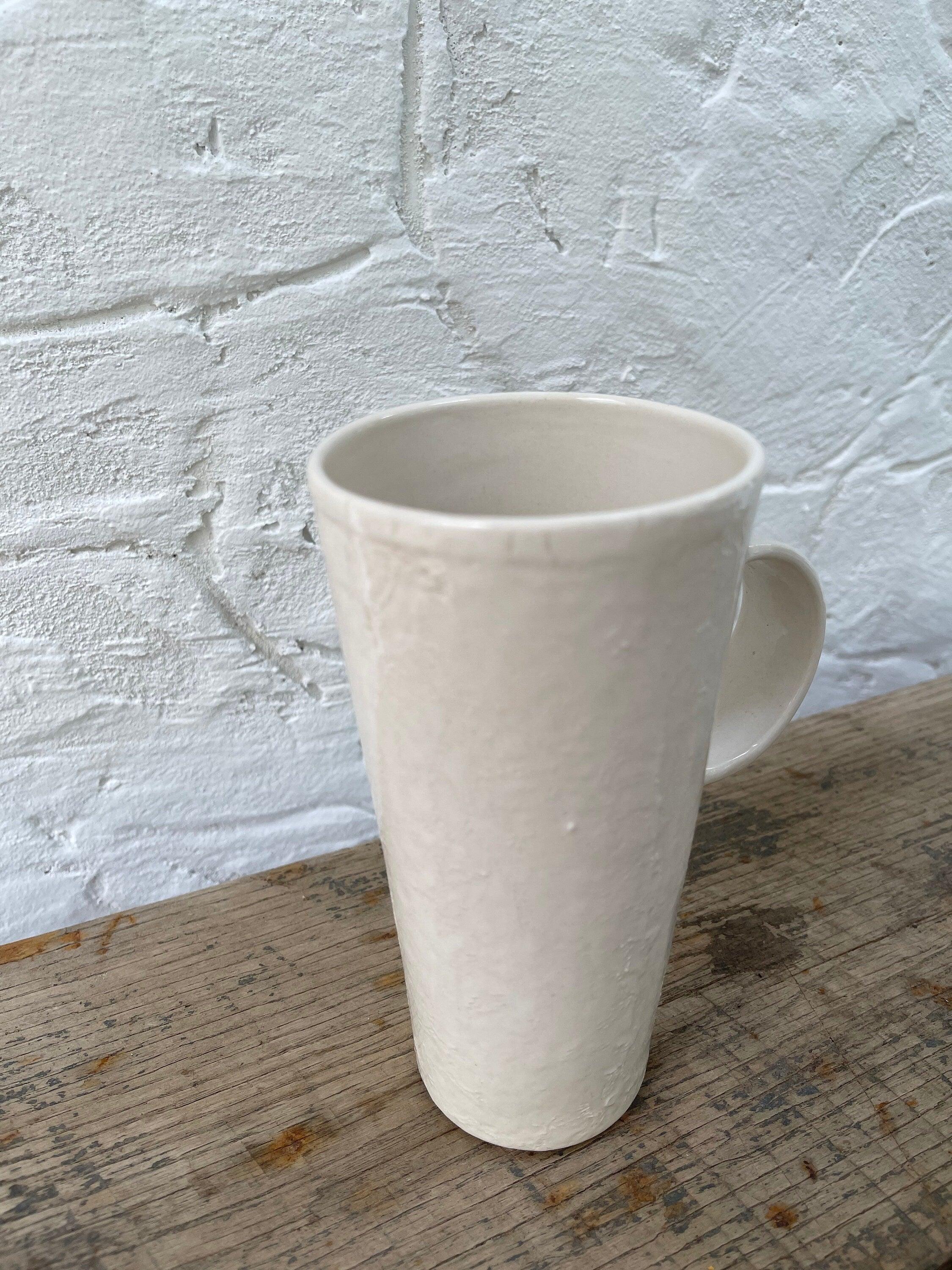 Handmade tall ceramic mug with delicate lace texture