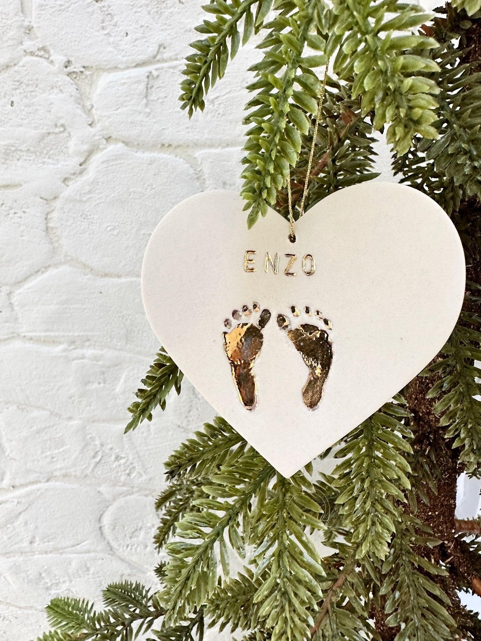 Custom baby name ornament with gold footprint design