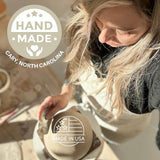 Handmade deep ceramic coffee mug with a carved star and stripe design