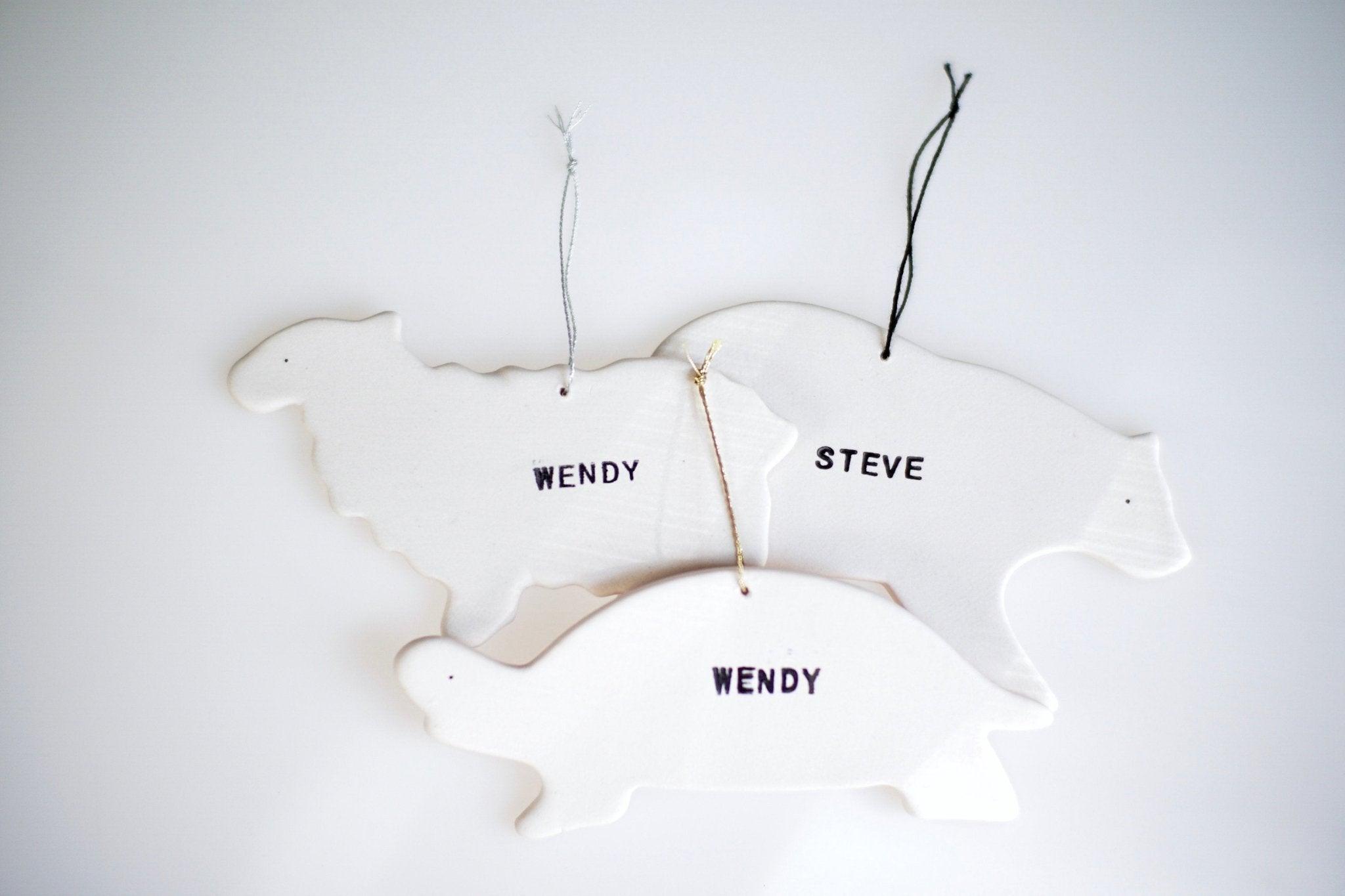 Handcrafted ceramic dinosaur ornament personalized with a child's name, additional view