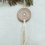 Handcrafted ceramic evil eye ornament with tassel, boho spiritual wall decor