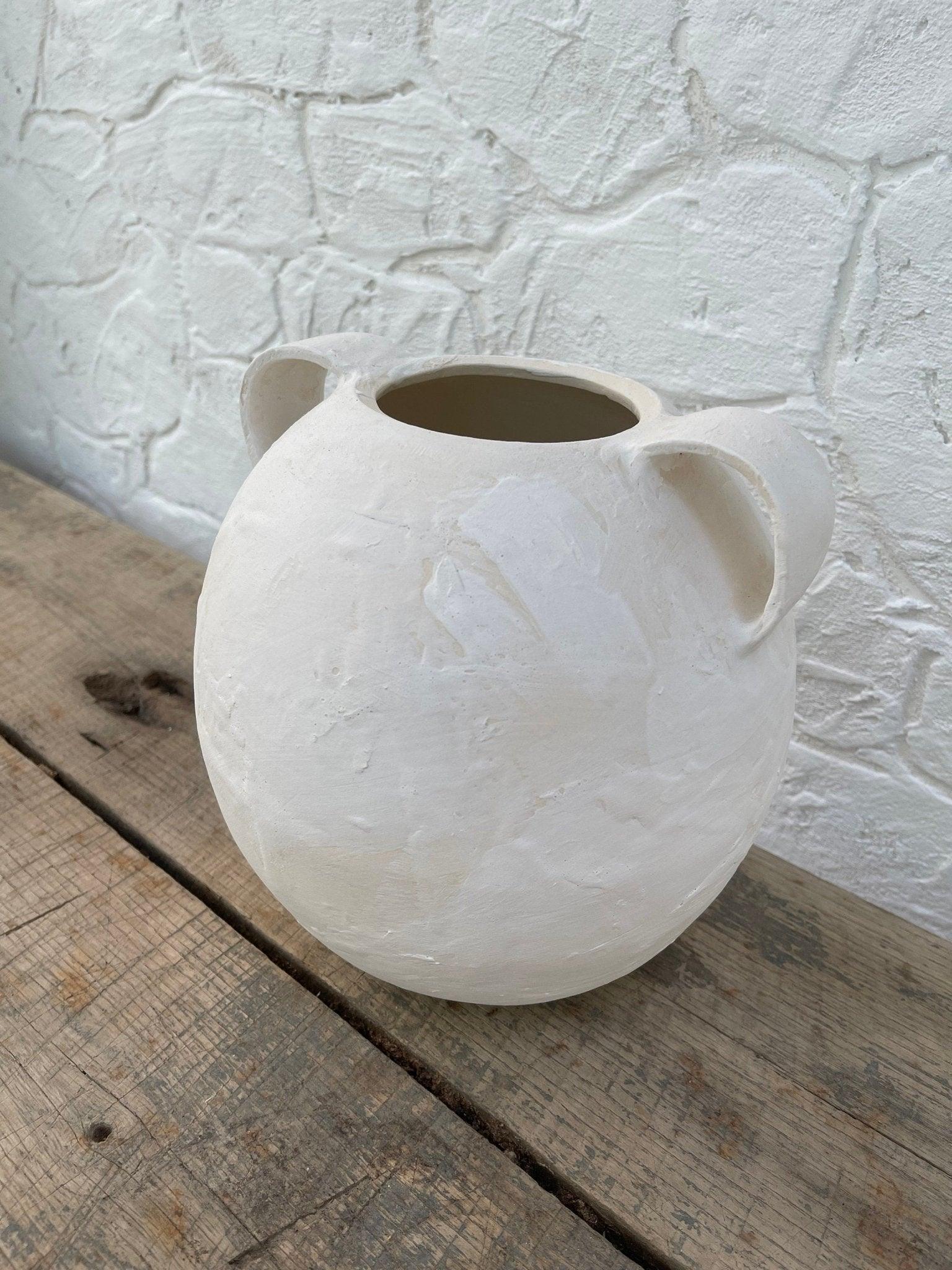 Handmade globe-shaped ceramic vessel with handles in a neutral glaze